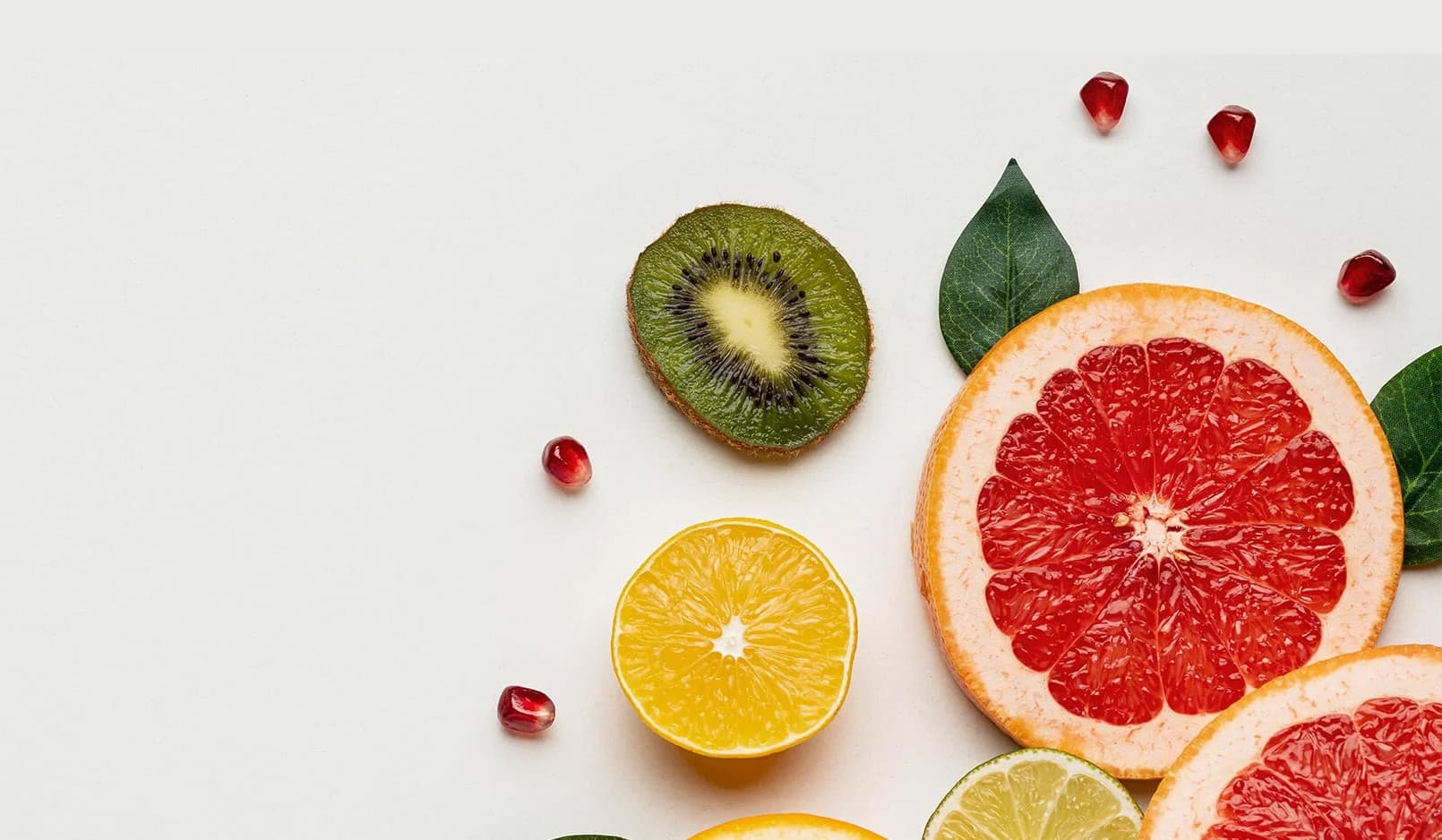 Sliced grapefruit, kiwi, orange and pomegranate seeds, flat-lay
