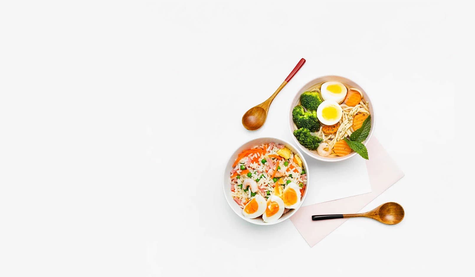 A vegetable noodle broth bowl and a rice bowl with soft-boiled egg, flat-lay
